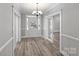 Bright entryway with modern chandelier, beautiful wood flooring and elegant trim at 220 W Bell St, Statesville, NC 28677