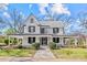 Charming two-story home featuring a wrap-around porch, a metal roof, and a well-manicured lawn at 220 W Bell St, Statesville, NC 28677