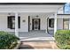 Inviting front porch with classic columns, black shutters, and well-maintained landscaping at 220 W Bell St, Statesville, NC 28677