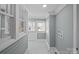 Hallway featuring tile floors, gray walls with white trim and utility hookups at 220 W Bell St, Statesville, NC 28677