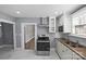 Kitchen featuring white cabinets, marble floors, and stainless steel appliances at 220 W Bell St, Statesville, NC 28677