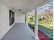 Beautiful porch featuring bright white columns, black shutters, and decorative foliage at 220 W Bell St, Statesville, NC 28677