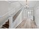 Beautiful staircase with wood and white accents leading to the upper level at 220 W Bell St, Statesville, NC 28677