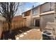 A fenced backyard with a small patio and stone walkway leading to a home with large windows and a sliding glass door at 2324 Brookview Ct, Rock Hill, SC 29732