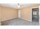 Spacious bedroom featuring carpeted floors, ceiling fan, and convenient doorway access at 2324 Brookview Ct, Rock Hill, SC 29732