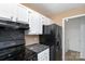 This kitchen features black appliances, light cabinets and dark countertops at 2324 Brookview Ct, Rock Hill, SC 29732