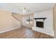 Cozy living room with wood-look floors, ceiling fan, and white brick fireplace at 2324 Brookview Ct, Rock Hill, SC 29732