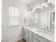 Bright bathroom with double sinks, granite counters, and modern fixtures at 2626 Palm Ave, Charlotte, NC 28205