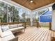 Covered deck with wood ceiling, ceiling fan, and cozy sectional at 2626 Palm Ave, Charlotte, NC 28205