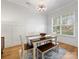 Traditional dining room featuring a wooden table, bench seating, and stylish chandelier at 2626 Palm Ave, Charlotte, NC 28205