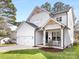 Charming two-story home featuring a pristine white exterior with decorative wood trim and a well-manicured lawn at 2626 Palm Ave, Charlotte, NC 28205