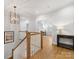 Bright hallway with wooden floors and staircase leading to a naturally lit second floor at 2626 Palm Ave, Charlotte, NC 28205