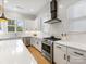 Bright kitchen with white cabinets, stainless steel appliances, subway tile backsplash, and quartz countertops at 2626 Palm Ave, Charlotte, NC 28205