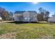 The back of the home features a large yard and a wooden deck at 280 Bonaventure Dr, Salisbury, NC 28147