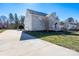 View of the back of the two-story home with a well-maintained lawn and deck at 280 Bonaventure Dr, Salisbury, NC 28147