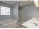 Bathroom featuring a jetted tub, glass block window, separate shower, and double sink vanity at 280 Bonaventure Dr, Salisbury, NC 28147