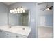 Bathroom featuring a double sink vanity and access to an attached bedroom with vaulted ceilings at 280 Bonaventure Dr, Salisbury, NC 28147