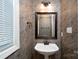 Cozy half bathroom with decorative wallpaper, mirror, and pedestal sink at 280 Bonaventure Dr, Salisbury, NC 28147