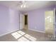 Light purple bedroom featuring plush carpets, ample space, and access to the closet at 280 Bonaventure Dr, Salisbury, NC 28147