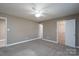 Neutral bedroom featuring a ceiling fan, plush carpet, and ample closet space at 280 Bonaventure Dr, Salisbury, NC 28147