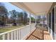 Covered front porch with a swing offering serene views of the surrounding landscape at 280 Bonaventure Dr, Salisbury, NC 28147