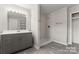 Modern bathroom featuring gray vanity, lighted mirror, and tiled walk-in shower at 2909 Glendale Ave, Kannapolis, NC 28081