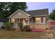 Charming single-story home with a cozy front porch and well-maintained landscaping at dusk at 2909 Glendale Ave, Kannapolis, NC 28081