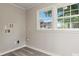 Bright laundry room featuring two windows and hook ups for a washer and dryer at 2909 Glendale Ave, Kannapolis, NC 28081