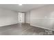 Open living space featuring light grey walls and wood-look floors at 2909 Glendale Ave, Kannapolis, NC 28081