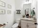 Powder room featuring a vanity with granite countertop, modern sink, and framed decorative art at 2929 Shumard Dr, Gastonia, NC 28054