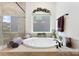 Bright bathroom featuring a garden tub and tile accents at 2929 Shumard Dr, Gastonia, NC 28054