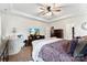 Main bedroom with a ceiling fan, large dresser, and neutral color palette at 2929 Shumard Dr, Gastonia, NC 28054