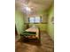 Bedroom featuring green walls with a ceiling fan and a bed with a sunflower patterned comforter at 2940 Ambrose Dr, Gastonia, NC 28056