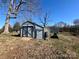 A storage shed in the backyard with a wooden ramp at 2940 Ambrose Dr, Gastonia, NC 28056