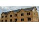 Exterior construction view of new townhomes with a partially installed roof and visible framing at 3018 Casting St # 20, Charlotte, NC 28206