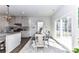 Bright dining area with a stylish table, chairs, and sliding glass doors providing natural light at 3180 Streamside Dr, Davidson, NC 28036