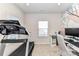 Bright home office featuring a treadmill, desk setup, and patterned wallpaper at 3180 Streamside Dr, Davidson, NC 28036