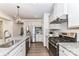 Modern kitchen featuring stainless steel appliances, granite countertops, and sleek gray cabinets at 3180 Streamside Dr, Davidson, NC 28036