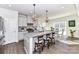 Elegant kitchen with gray cabinets, granite countertops, and pendant lighting at 3180 Streamside Dr, Davidson, NC 28036