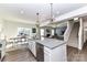 Open-concept kitchen featuring a large island and modern finishes, seamlessly connecting to the dining and living areas at 3180 Streamside Dr, Davidson, NC 28036