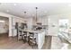 Bright kitchen with stainless steel appliances, granite counters, and a center island with barstool seating at 3180 Streamside Dr, Davidson, NC 28036