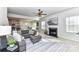 Open-concept living room with a fireplace, gray sectional, and view of the kitchen at 3180 Streamside Dr, Davidson, NC 28036