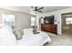 Comfortable main bedroom with large windows, a ceiling fan, and a view of the en-suite bathroom at 3180 Streamside Dr, Davidson, NC 28036