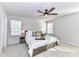 Serene main bedroom with natural light, soft carpets, and a ceiling fan for added comfort at 3180 Streamside Dr, Davidson, NC 28036