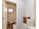 Cozy powder room with rustic decor, including a decorative bench and accent pillows at 3180 Streamside Dr, Davidson, NC 28036