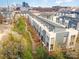 Modern townhomes feature a central walking path and a downtown city skyline in the background at 3621 Vallette Ct, Charlotte, NC 28203