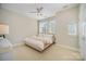 Cozy bedroom featuring a ceiling fan, natural light, and a neutral color palette with a pink bed frame at 3621 Vallette Ct, Charlotte, NC 28203