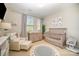 Bright Bedroom featuring a crib, dresser with changing table, soft chair, and playful animal prints at 3621 Vallette Ct, Charlotte, NC 28203