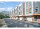 Contemporary townhouses featuring gray siding, brick details, and private garage parking at 3621 Vallette Ct, Charlotte, NC 28203