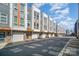 Row of modern townhomes featuring gray siding, brick accents, and individual garage doors at 3621 Vallette Ct, Charlotte, NC 28203